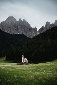 Scenic view of land and mountains against sky