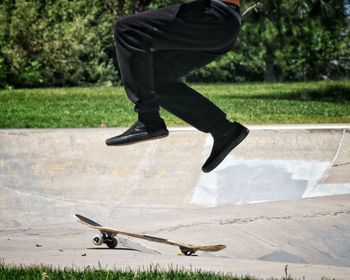 Low section of man skateboarding on skateboard