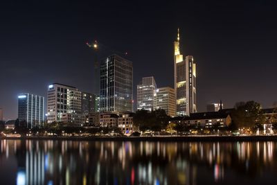 Reflection of illuminated buildings in city at night