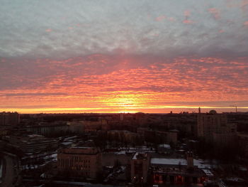 Aerial view of cityscape against sky during sunset