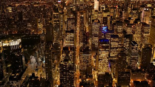 High angle view of city lit up at night