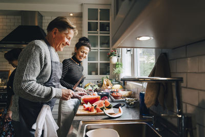 Woman preparing food in kitchen at home