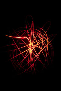 Illuminated light painting against black background