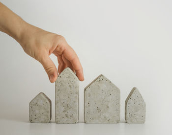 Mini house models and hand on the white background. buy a house. concept for property ladder