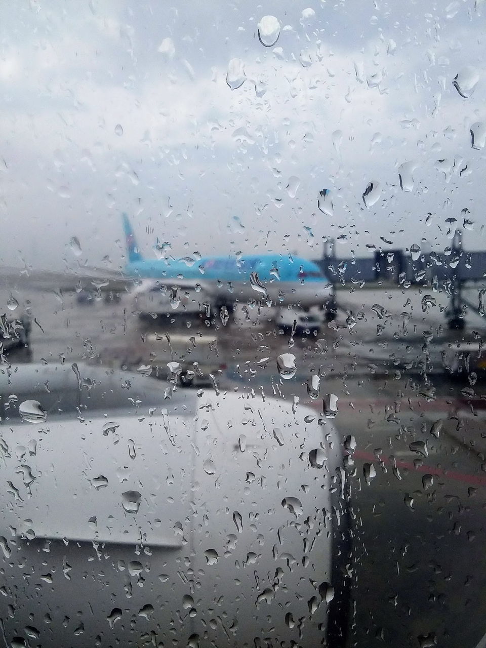 FULL FRAME SHOT OF RAINDROPS ON GLASS WINDOW