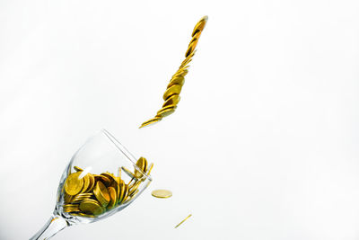 Close-up of yellow glass over white background