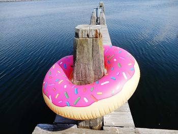 High angle view of inflatable ring in wood over lake