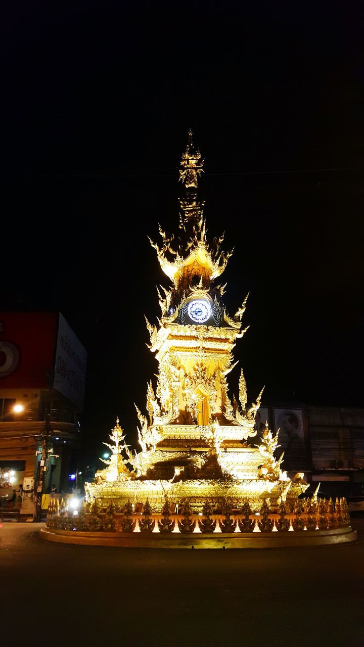 LOW ANGLE VIEW OF ILLUMINATED STATUE OF CATHEDRAL