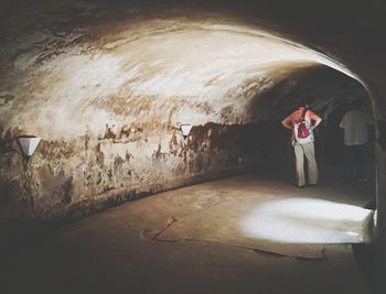 Man standing against wall