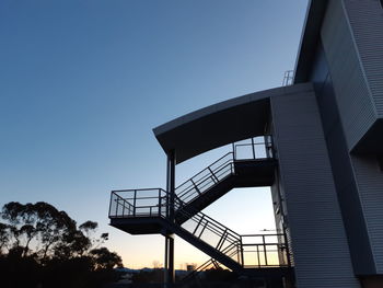 Low angle view of silhouette building against clear sky