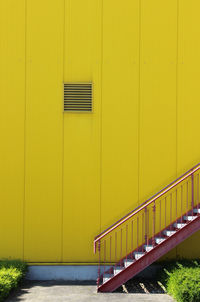 Staircase by yellow wall