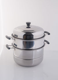 Close-up of steel cooking pot on white background