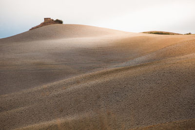 Sand dunes in desert against sky