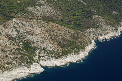 High angle view of rocks by sea