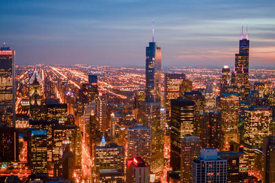 Aerial view of city lit up at night