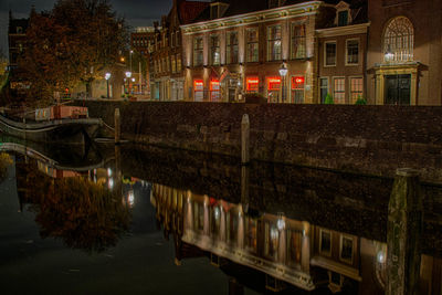 View of canal in city at night