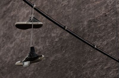 Low angle view of shoes hanging on wall