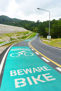 Beware bike sign painted on a bike lane in the dam area and public park