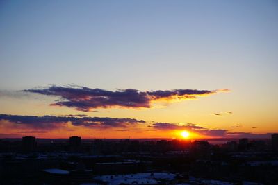 Silhouette buildings against sky during sunset