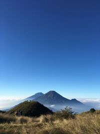 Scenic view of mountains against clear blue sky