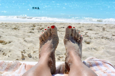 Low section of woman at beach