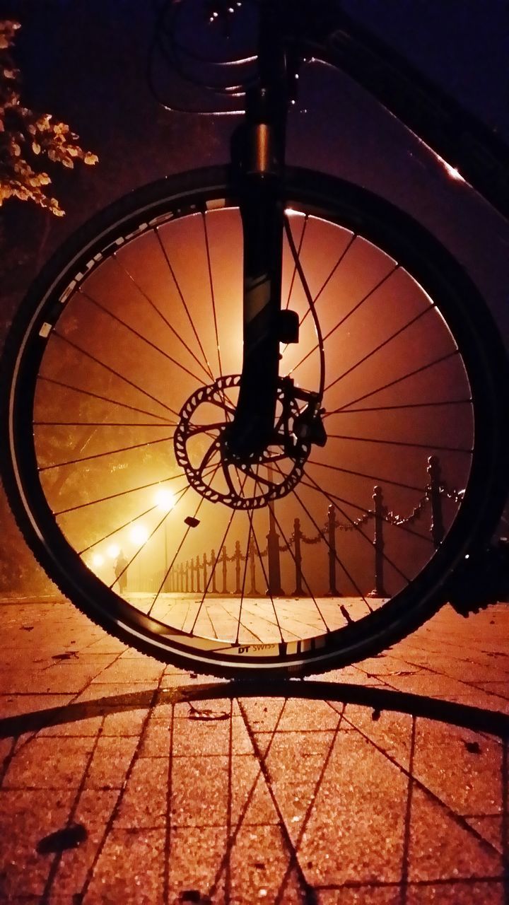 LOW SECTION OF BICYCLE PARKED ON COBBLESTONE