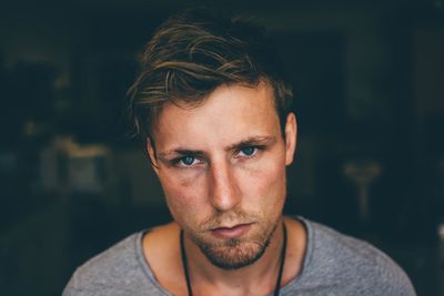 Portrait of serious young man at home