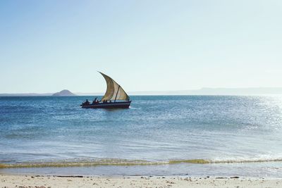 Sailboat on sea against clear sky