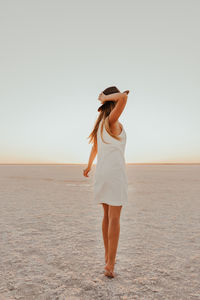 Young woman standing at beach