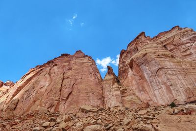 Low angle view of rock formations against blue sky