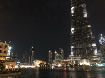 Low angle view of skyscrapers lit up at night