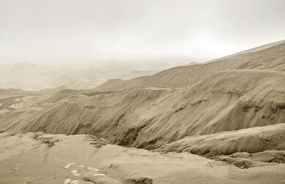 Scenic view of arid landscape against sky