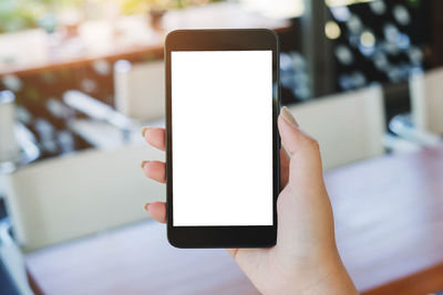Close-up of hand holding mobile phone