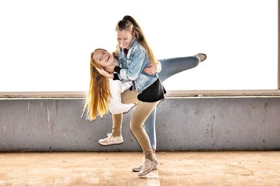 Playful siblings on walkway