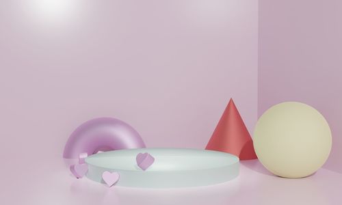 Close-up of multi colored balloons on table against wall