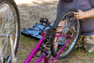 Low section of man riding bicycle on land