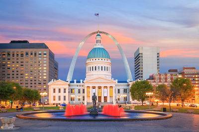 Buildings in city at sunset