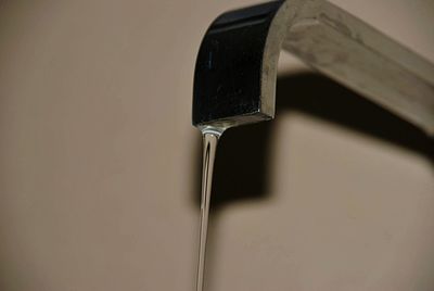 High angle view of metallic object over water against white background