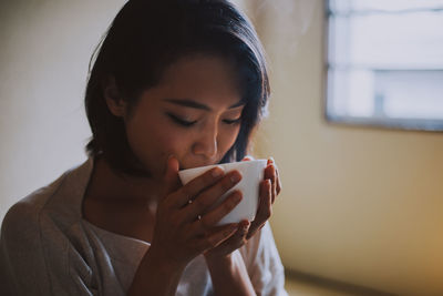 Young woman drinking coffee cup