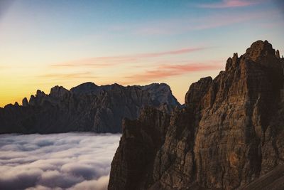 Scenic view of rocky mountains against sky during sunset