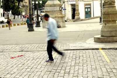 Full length of woman standing on footpath