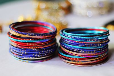 Close-up of stacked colorful bangles on table