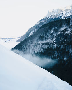 Scenic view of snowcapped mountains against clear sky