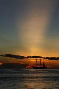 Silhouette ship on sea against sky during sunset