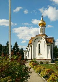 Church by building against sky