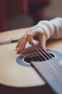 Little girl plays the guitar.