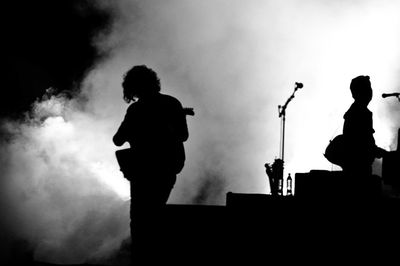 Low angle view of silhouette trees against sky