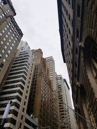 Low angle view of buildings in city against sky