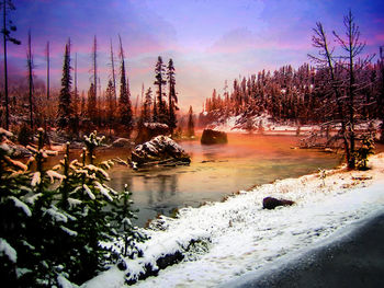 Scenic view of lake against sky during winter