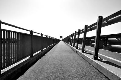 Footbridge against clear sky